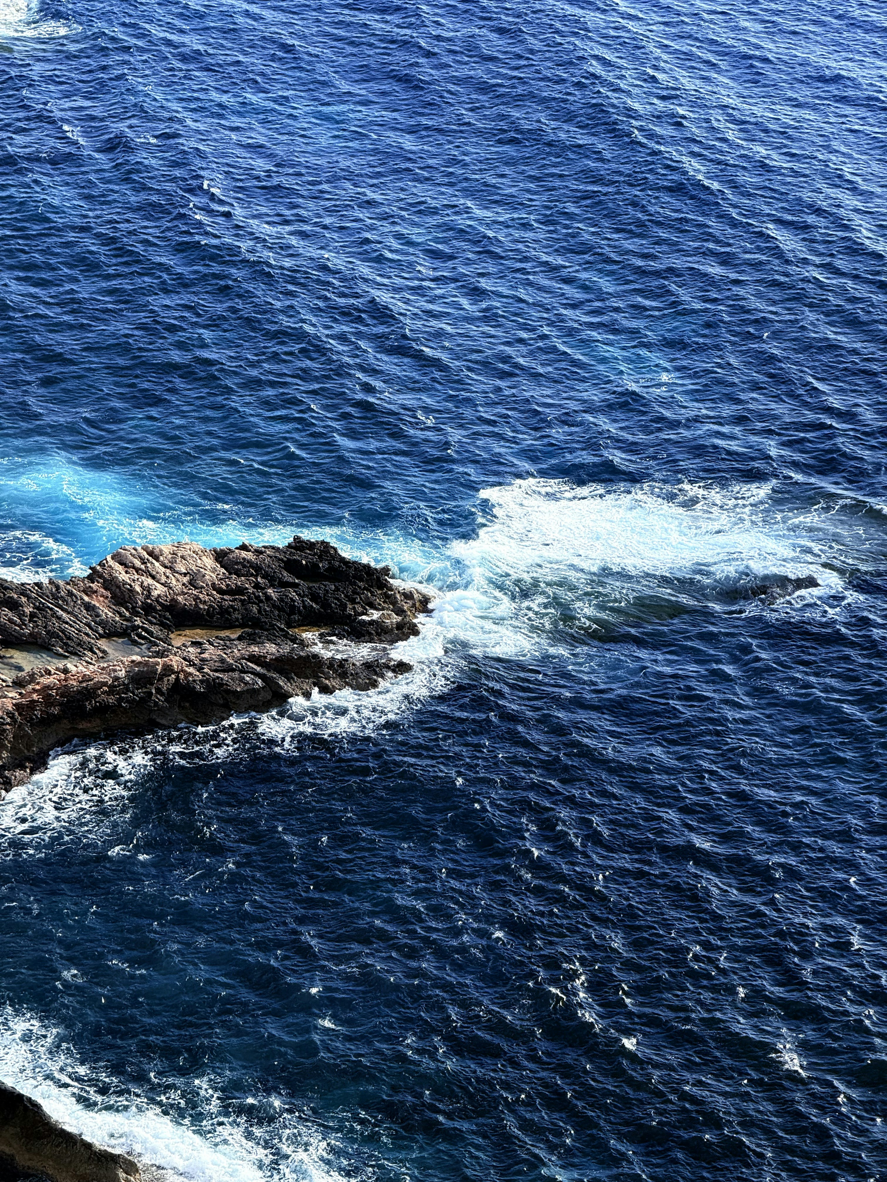 A couple of boats floating on top of a body of water