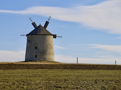 A windmill in the middle of a field
