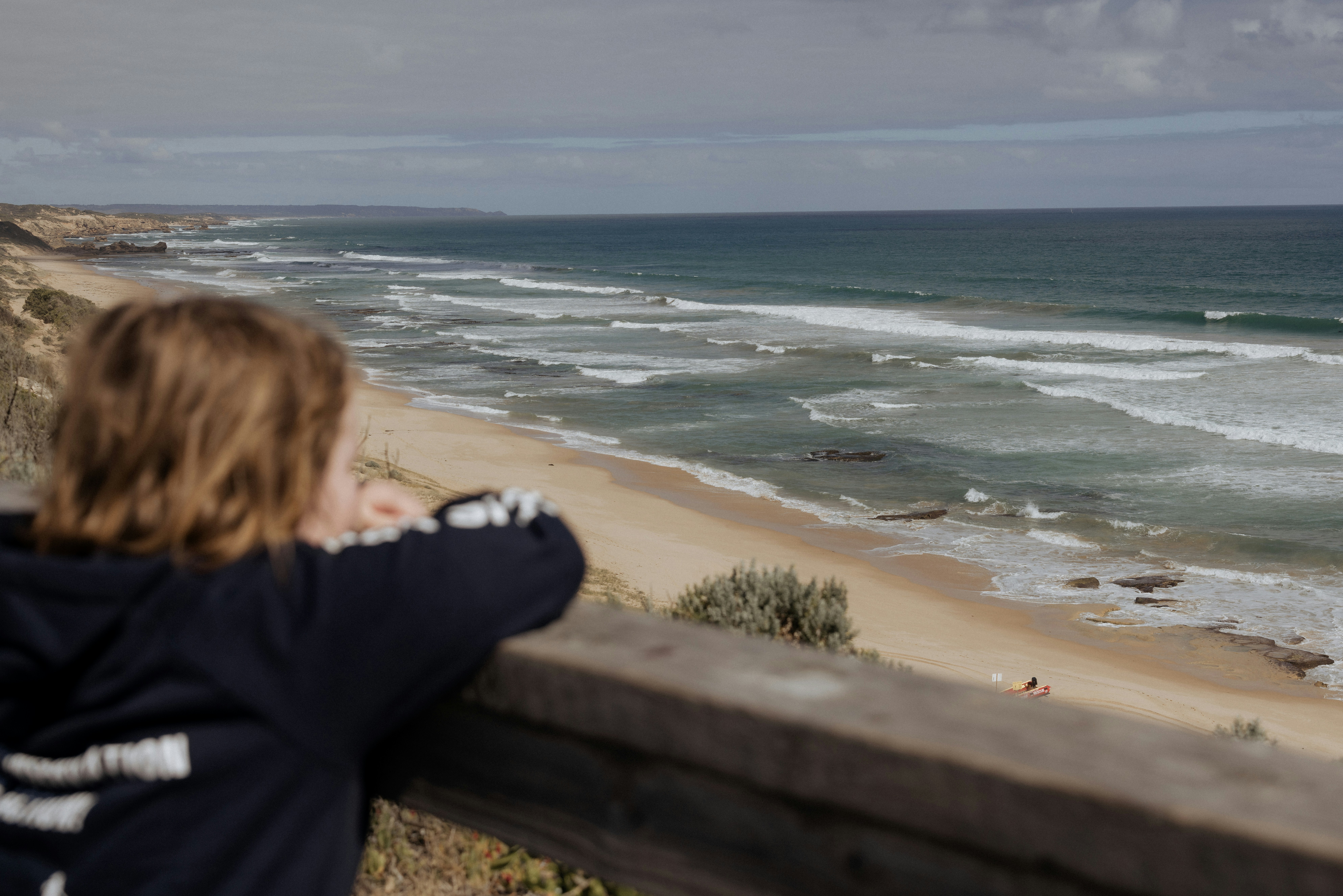 A woman looking out over the ocean at a beach