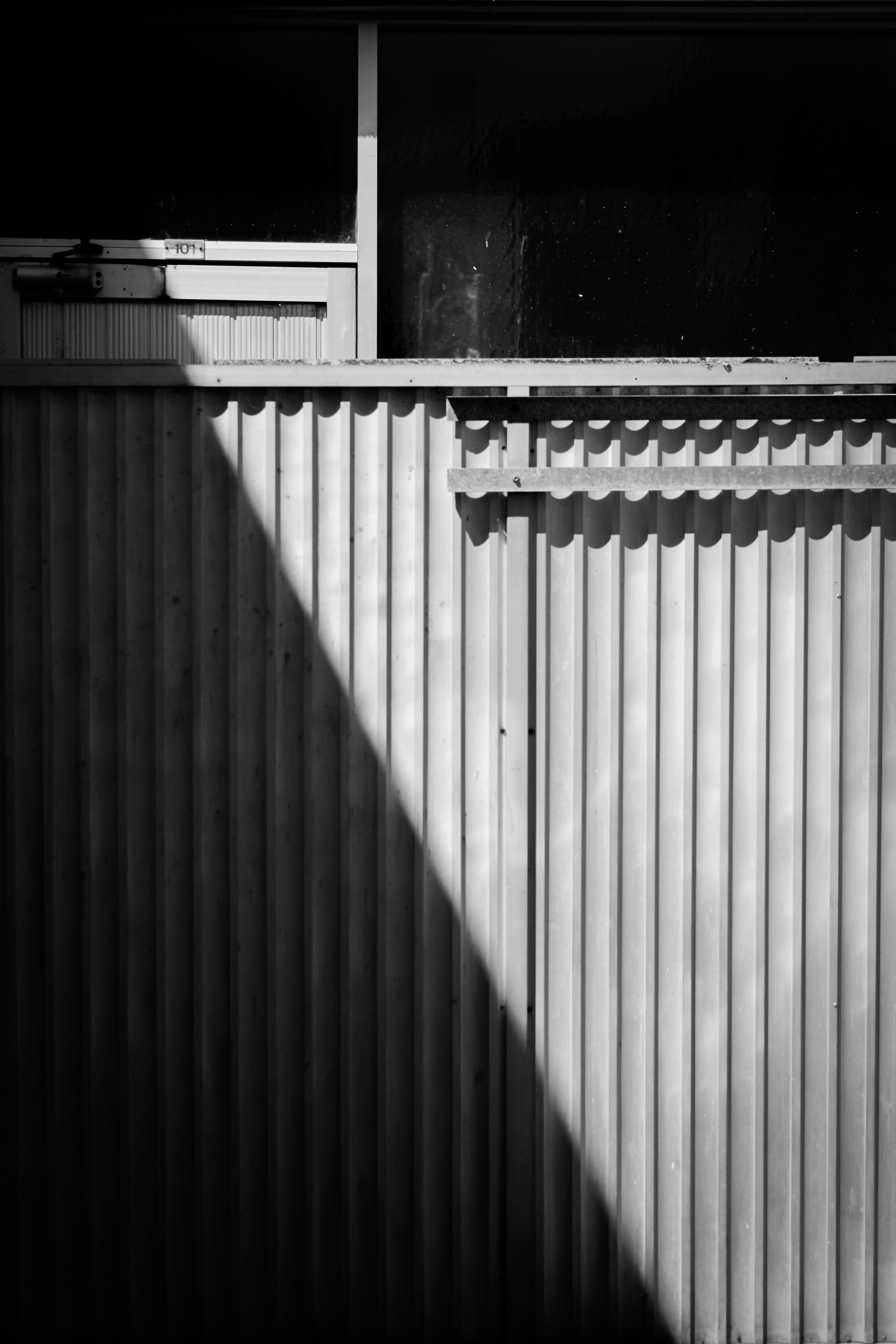 A black and white photo of a metal fence