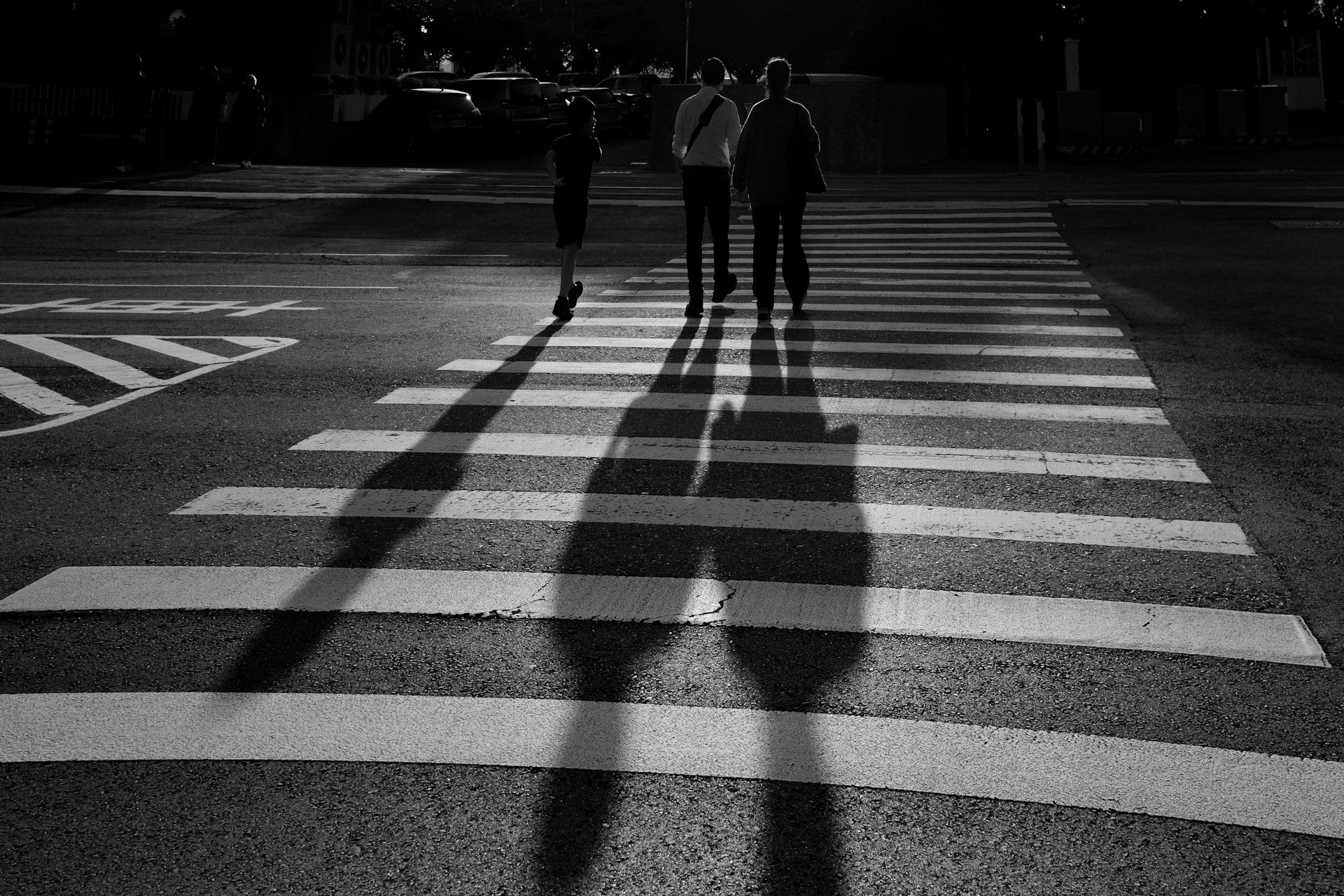 A group of people walking across a cross walk