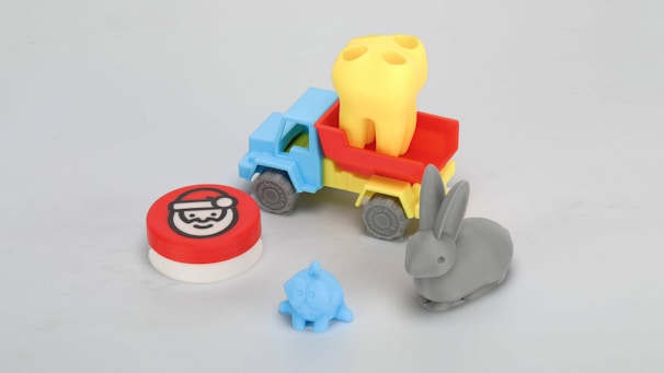A small toy truck with a small toy elephant