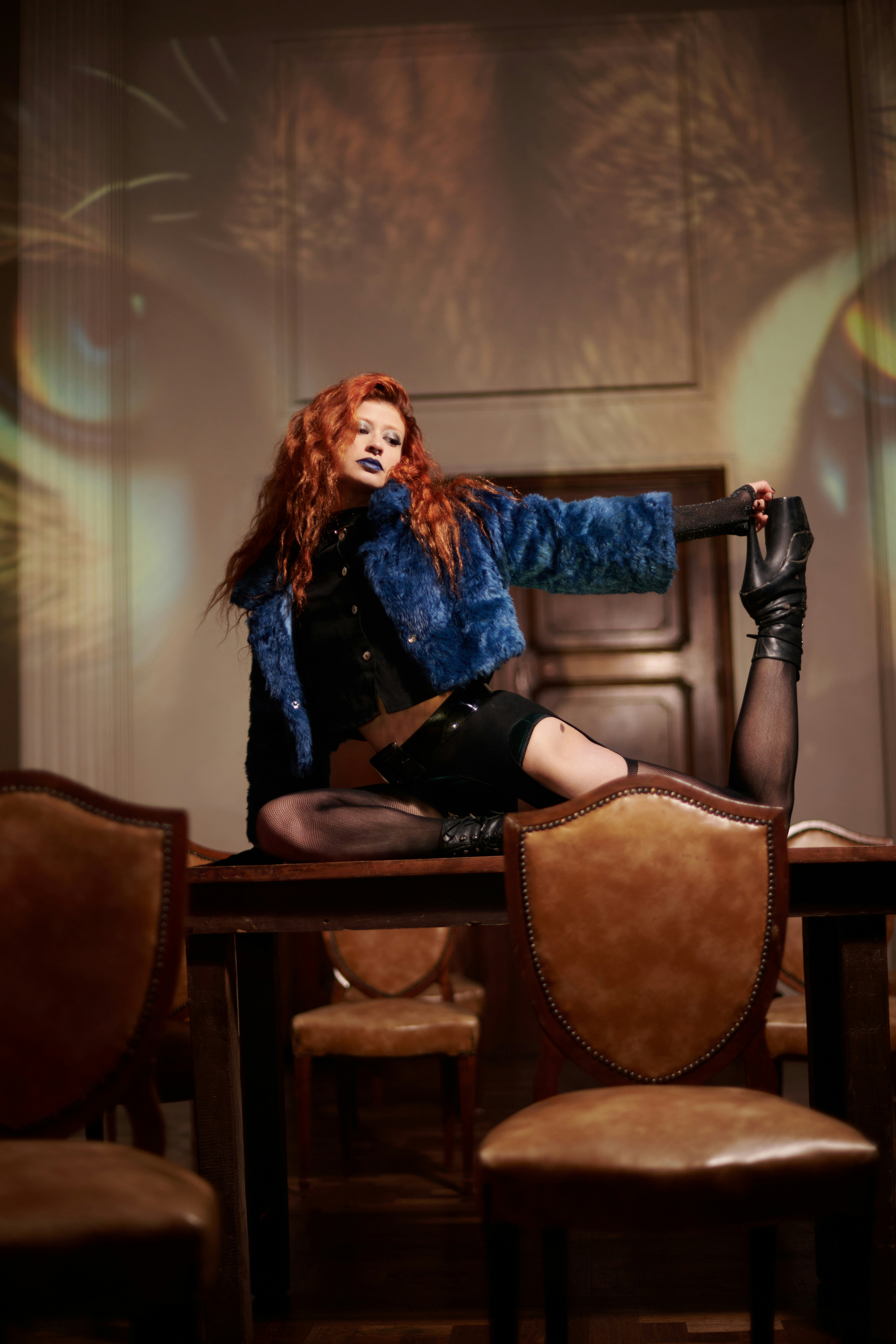 A woman sitting on top of a wooden table