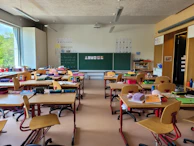 A classroom filled with lots of desks and chairs
