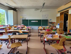 A classroom filled with lots of desks and chairs
