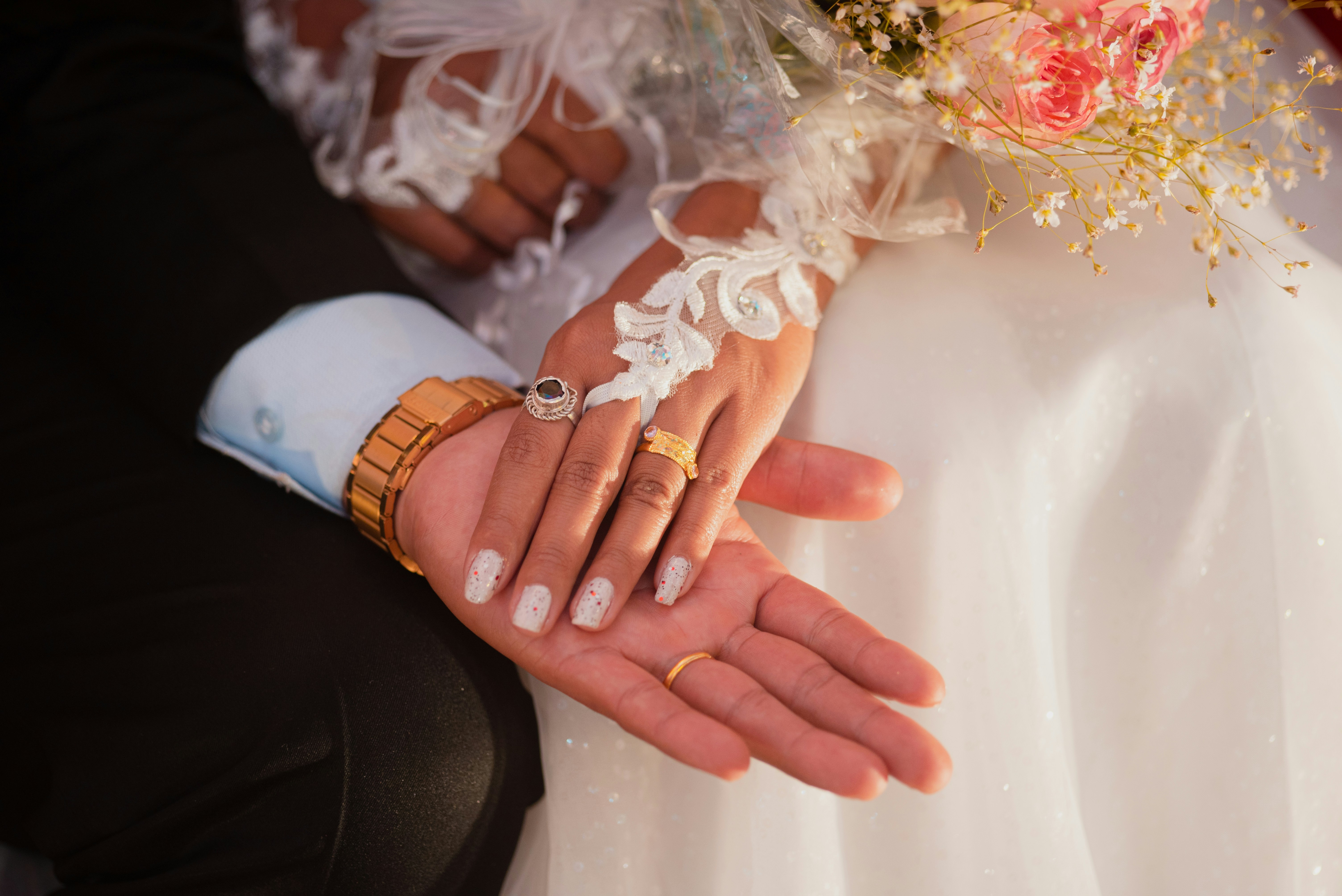 A bride and groom holding each other's hands