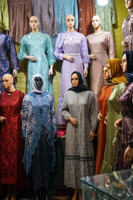 A group of mannequins are standing in front of a display