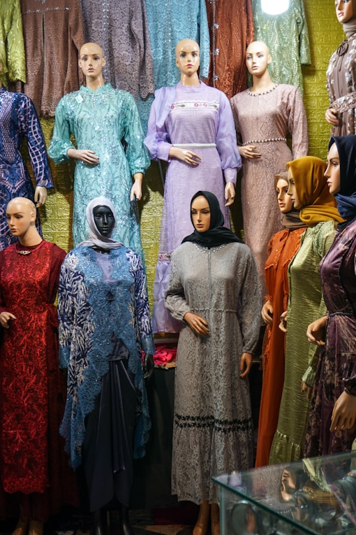 A group of mannequins are standing in front of a display