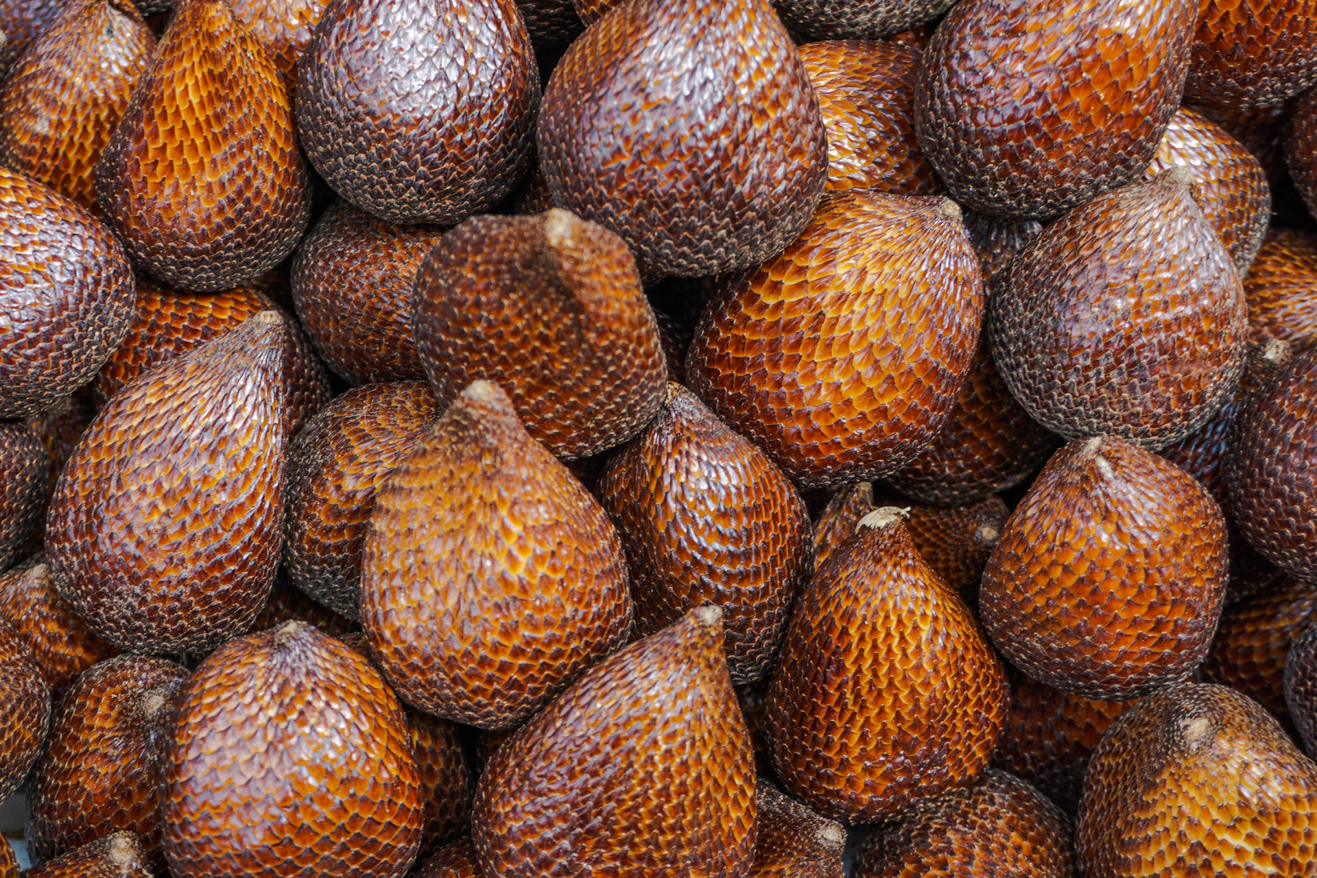 A large pile of fruit sitting on top of a table