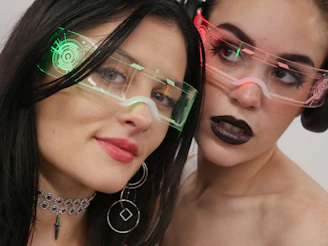Two women with glasses on their faces posing for a picture