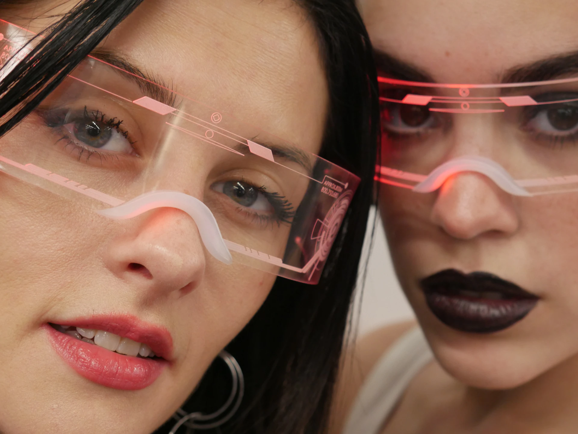Two beautiful women wearing glasses with lipstick on them