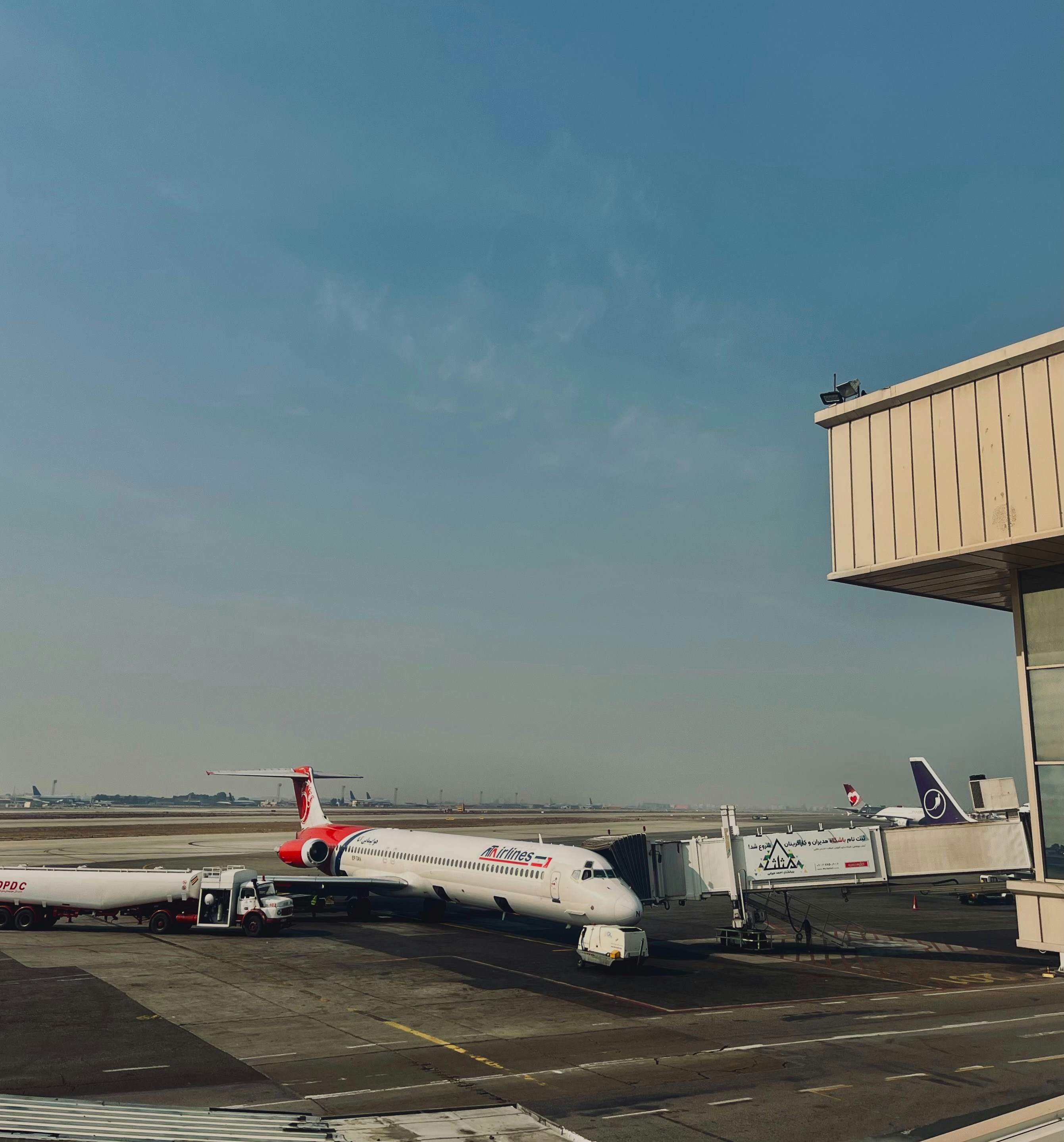 A large jetliner sitting on top of an airport tarmac