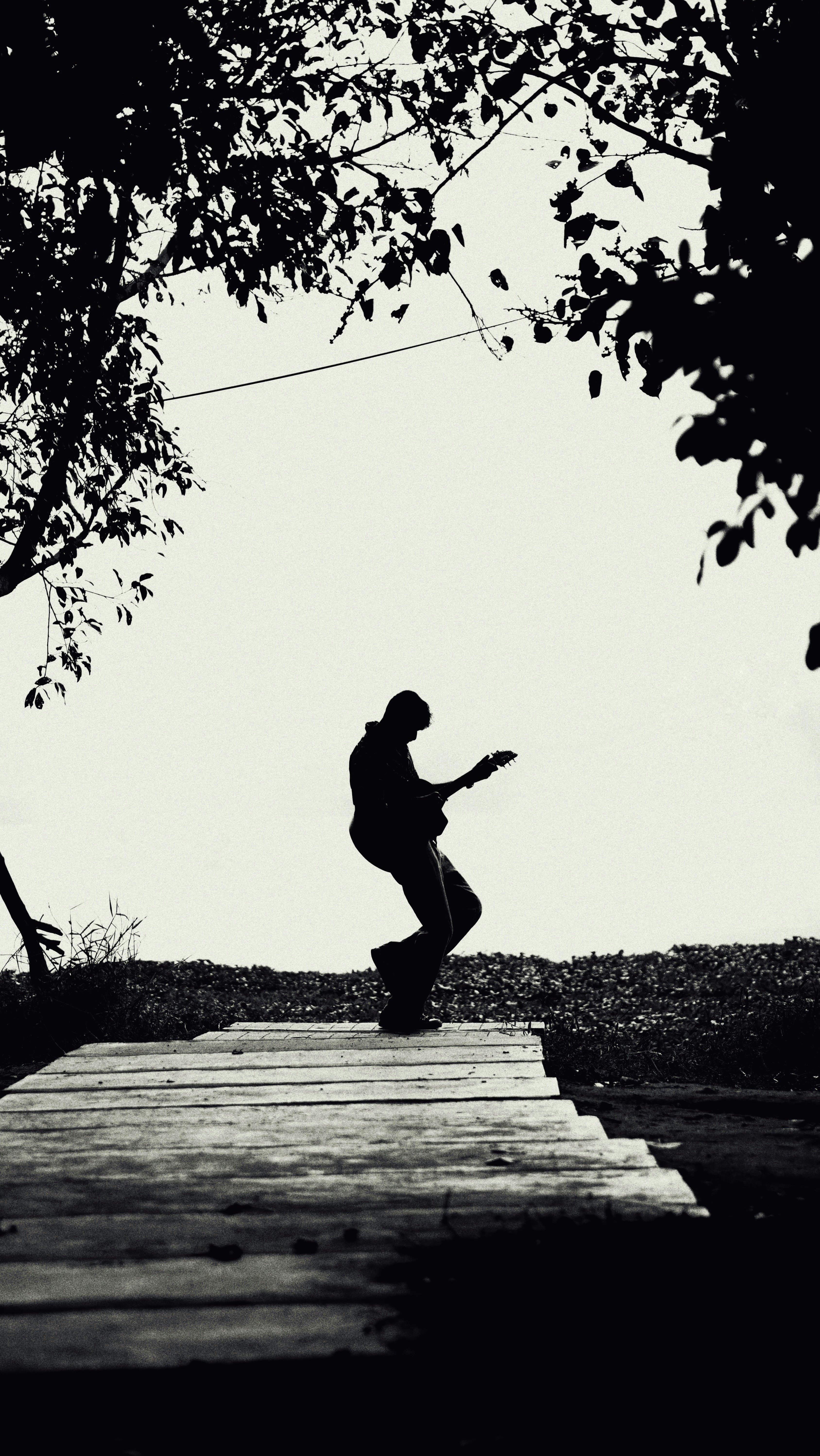A man riding a skateboard down a wooden ramp