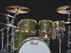 A green drum set sitting on top of a black background