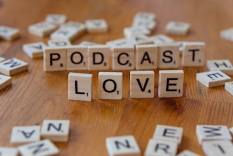 A wooden table topped with scrabble letters spelling out the word love