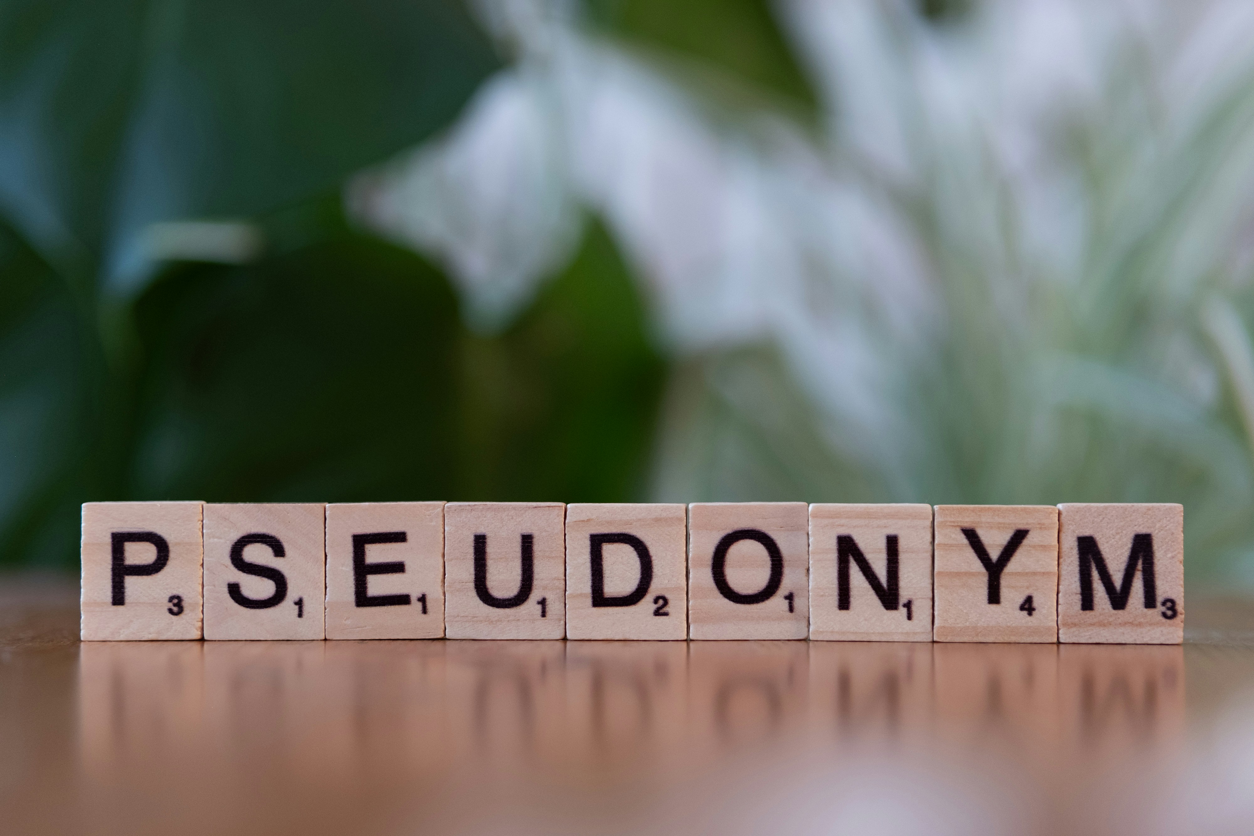 A scrabble type block spelling the word pedunym
