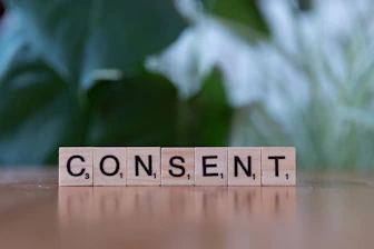 A wooden block spelling content on a table