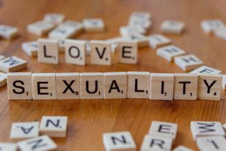 Scrabble tiles spelling love, sex, and sexuality