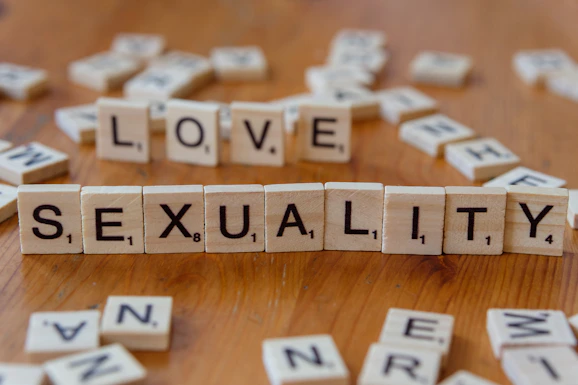 Scrabble tiles spelling love, sex, and sexuality