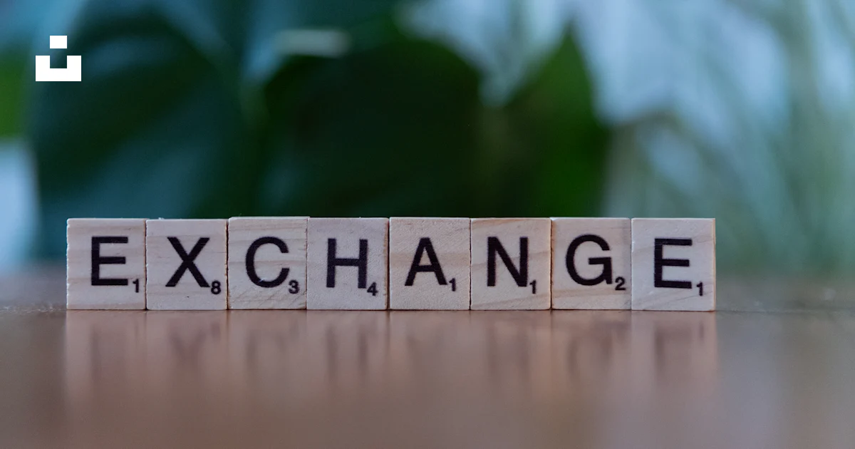 A scrabble block spelling the word exchange on a table photo – Free ...
