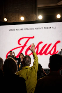 A group of people standing in front of a large screen