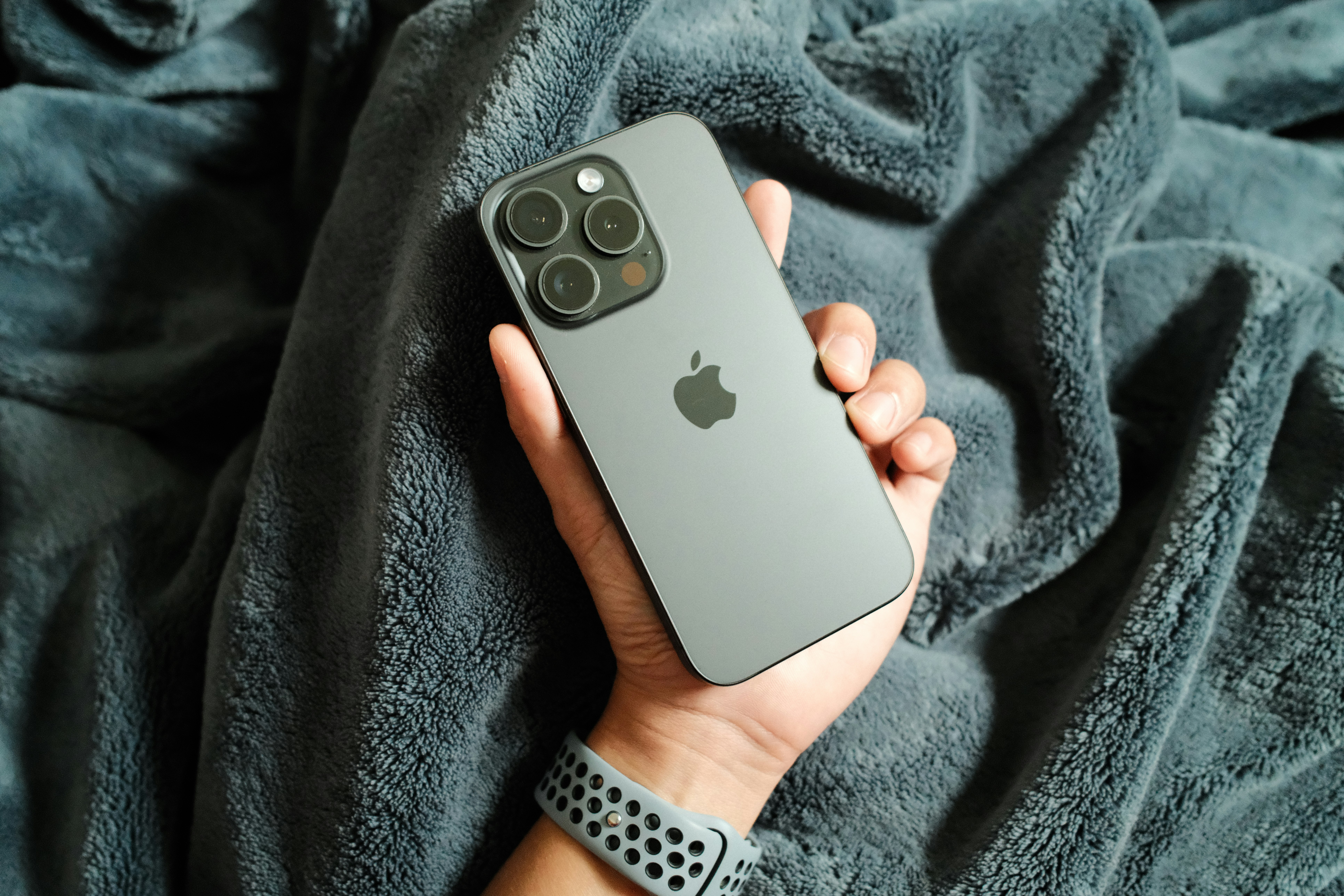 A person holding an iPhone in their hand