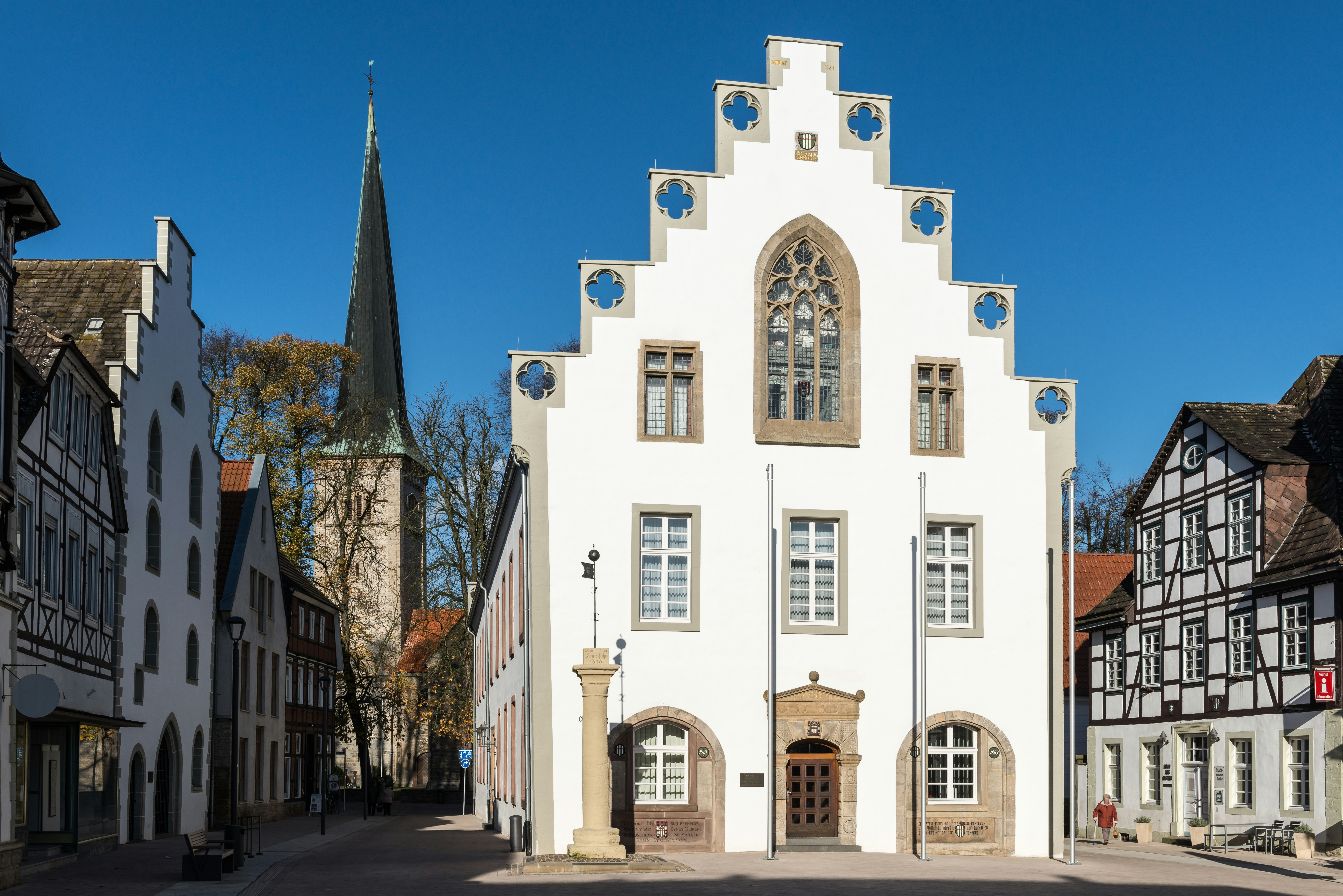 A large white building with a clock on it's side