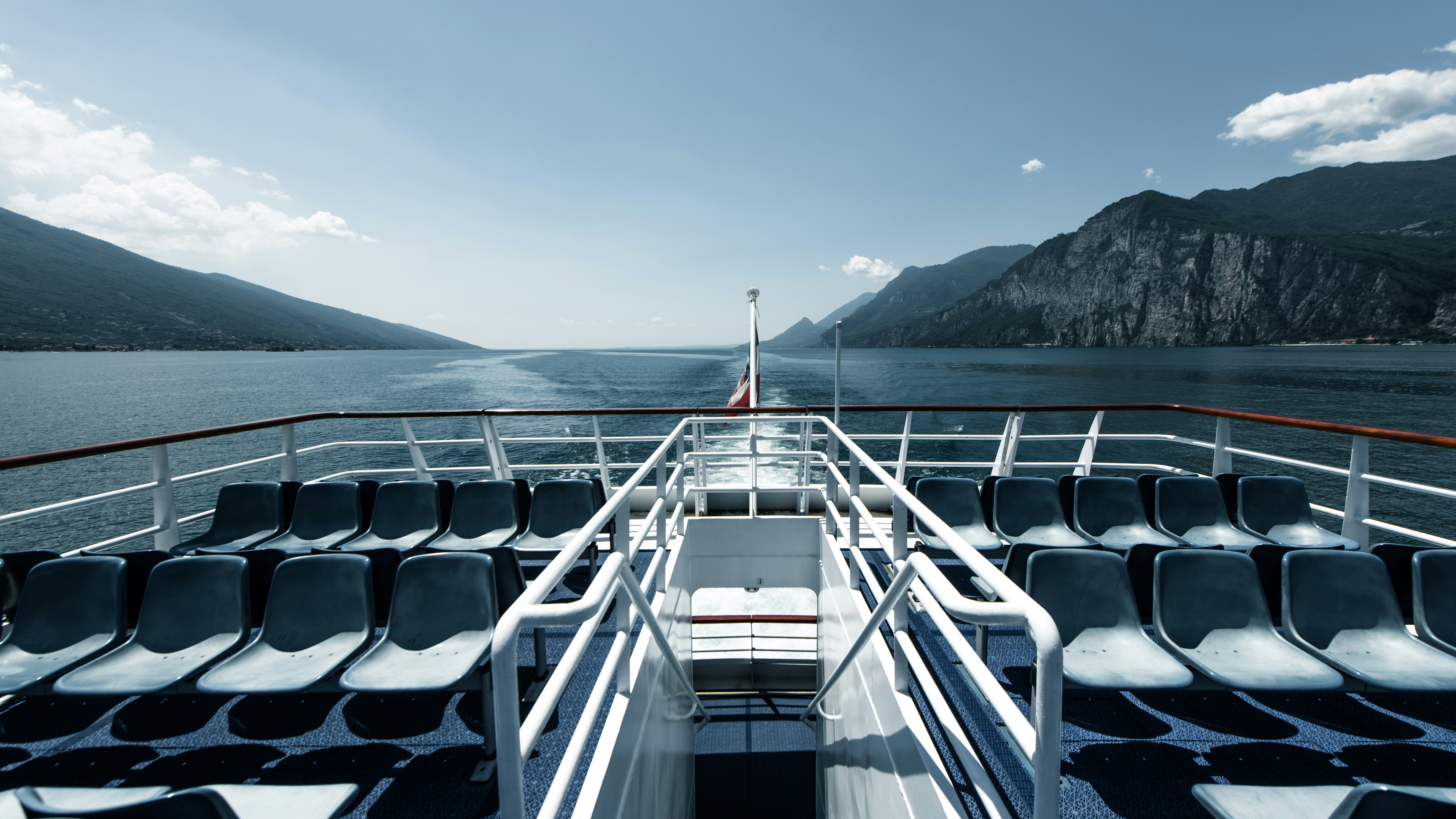 The back of a boat traveling across a body of water