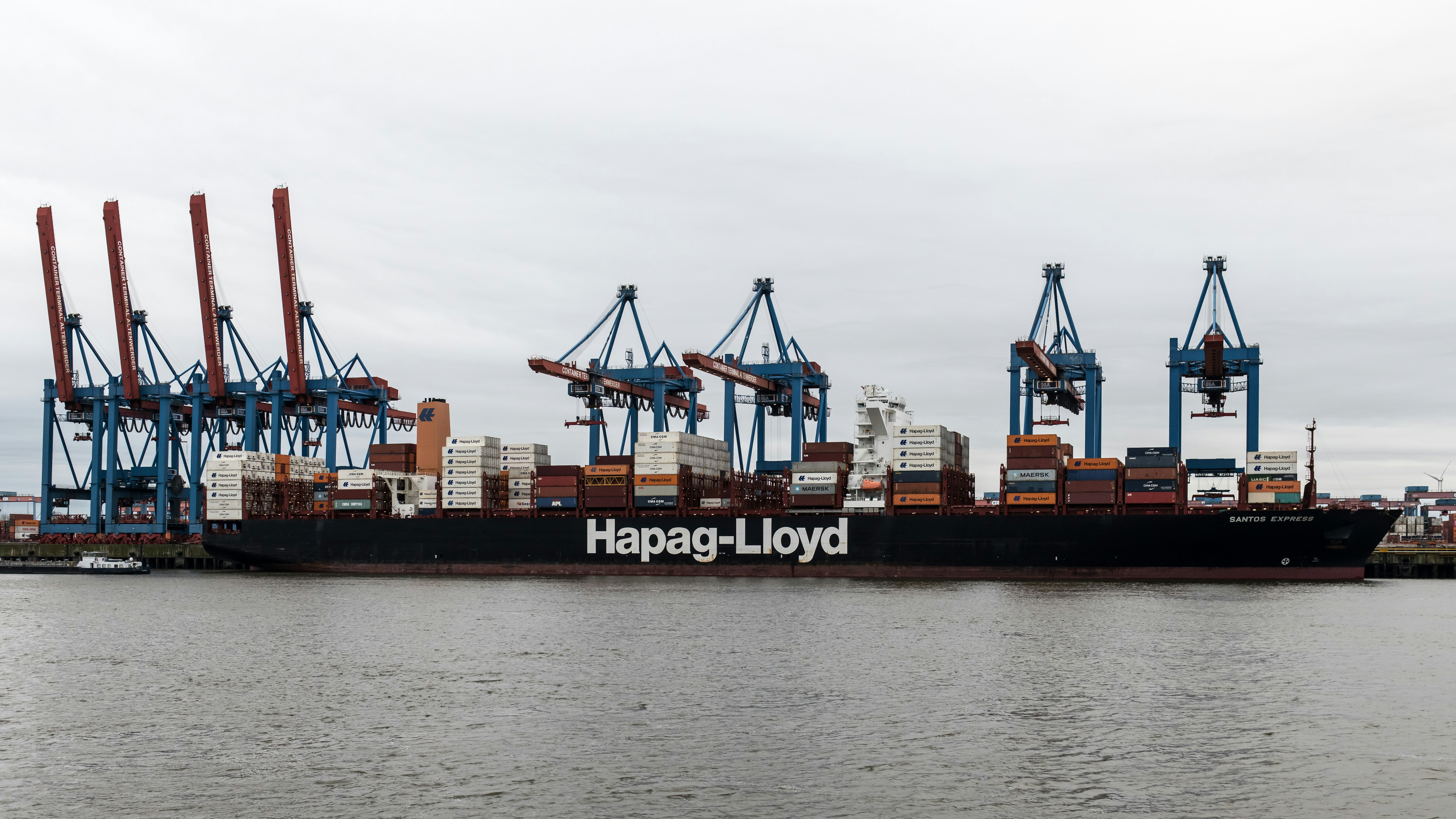 A large cargo ship is docked in the water