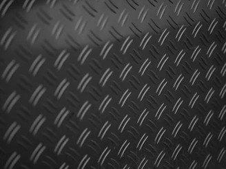 A black and white photo of a metal surface