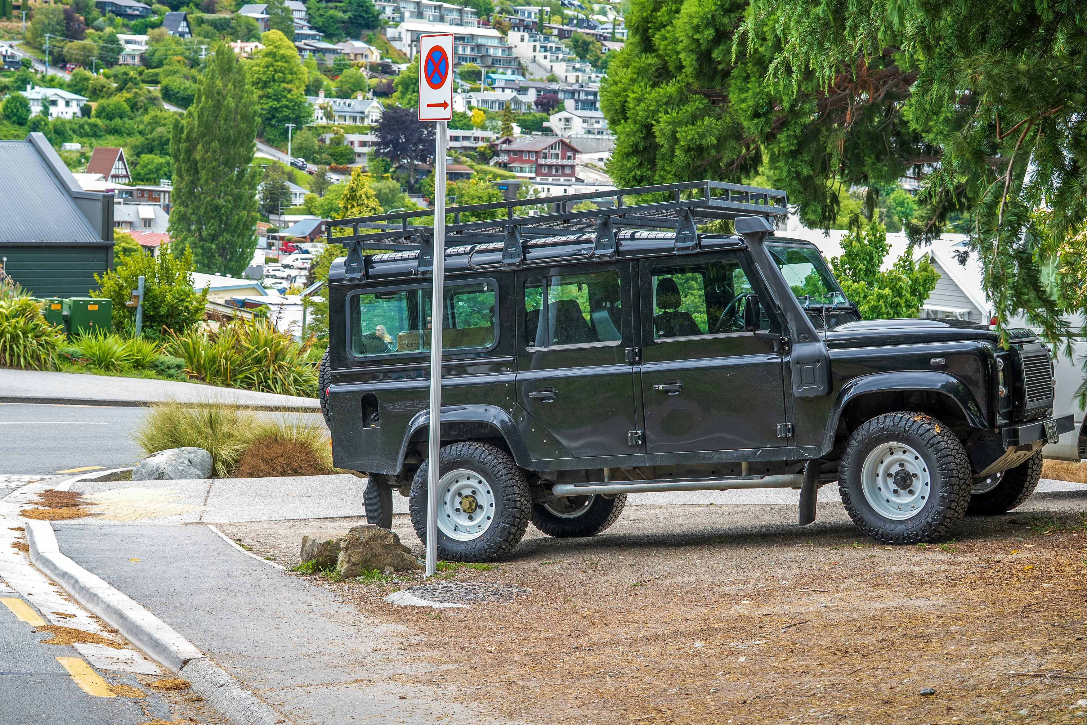 A black land rover parked on the side of the road