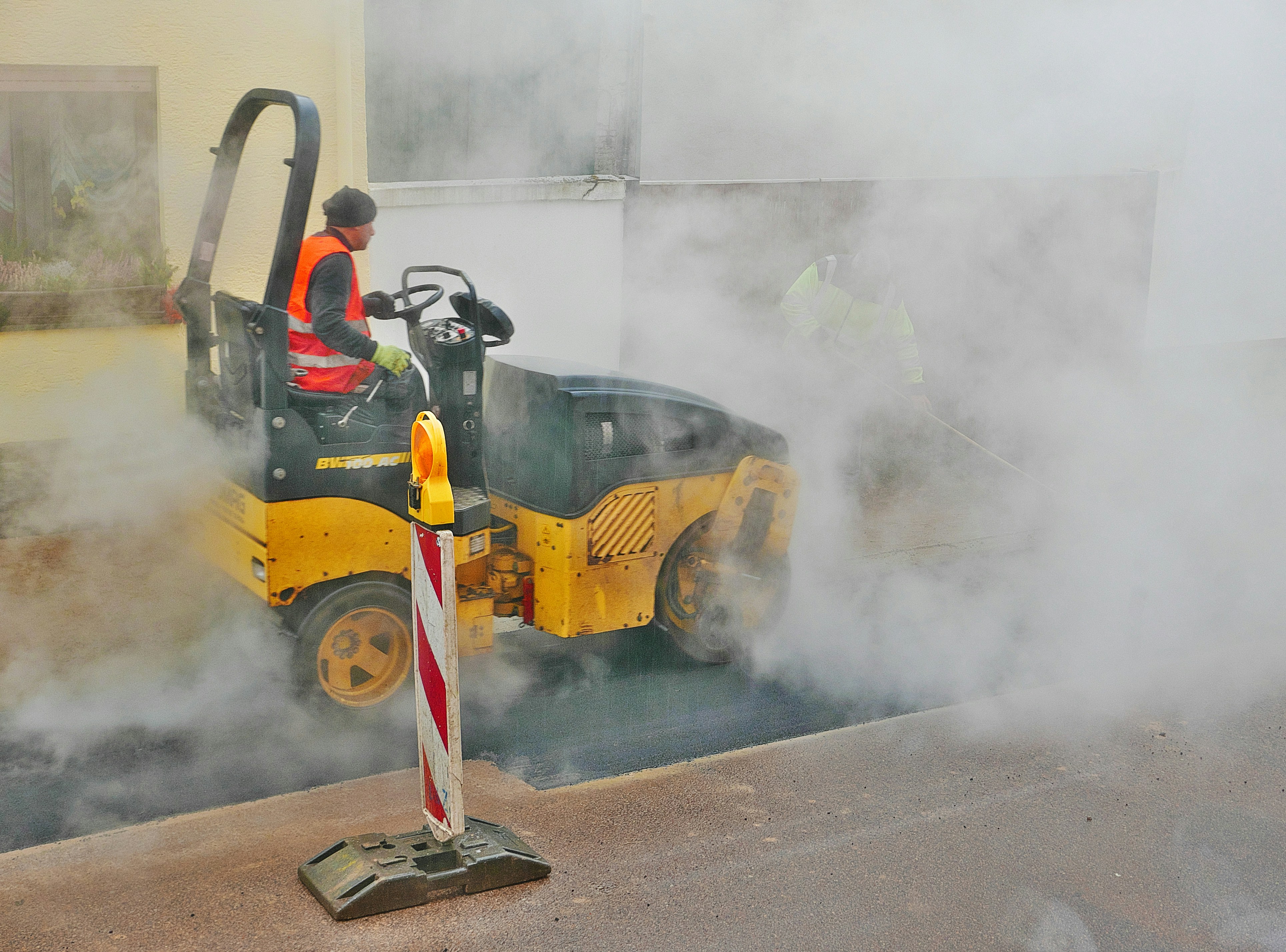 A person on a small yellow vehicle in the middle of a street