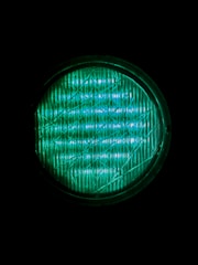 A close up of a green light in the dark