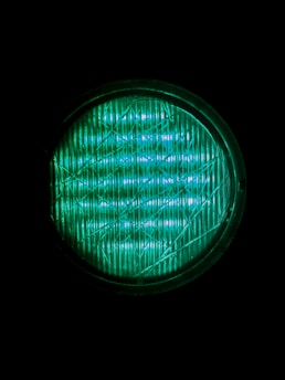 A close up of a green light in the dark