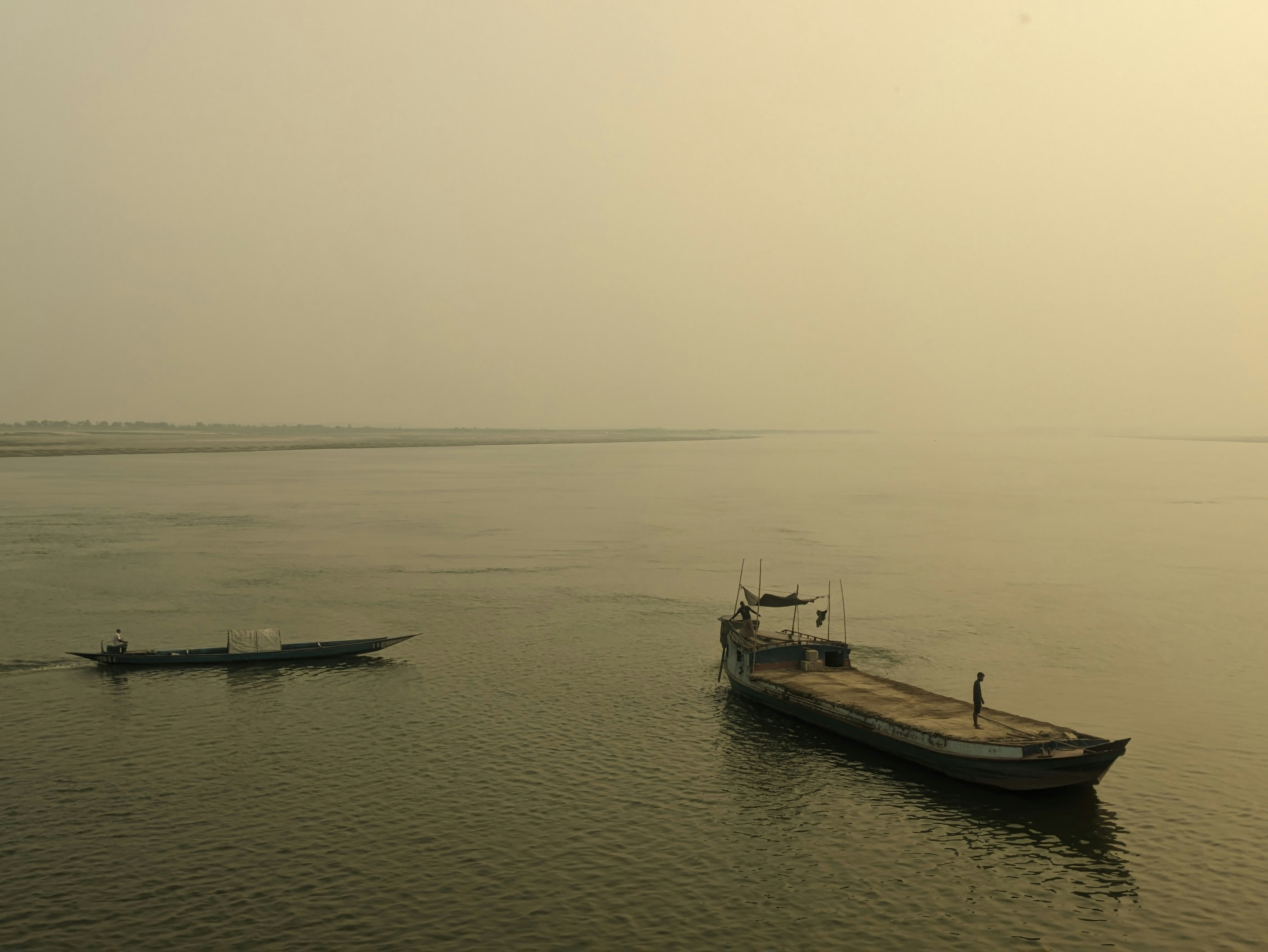 A boat is in the middle of a large body of water