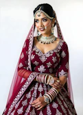 A woman in a red and white wedding outfit