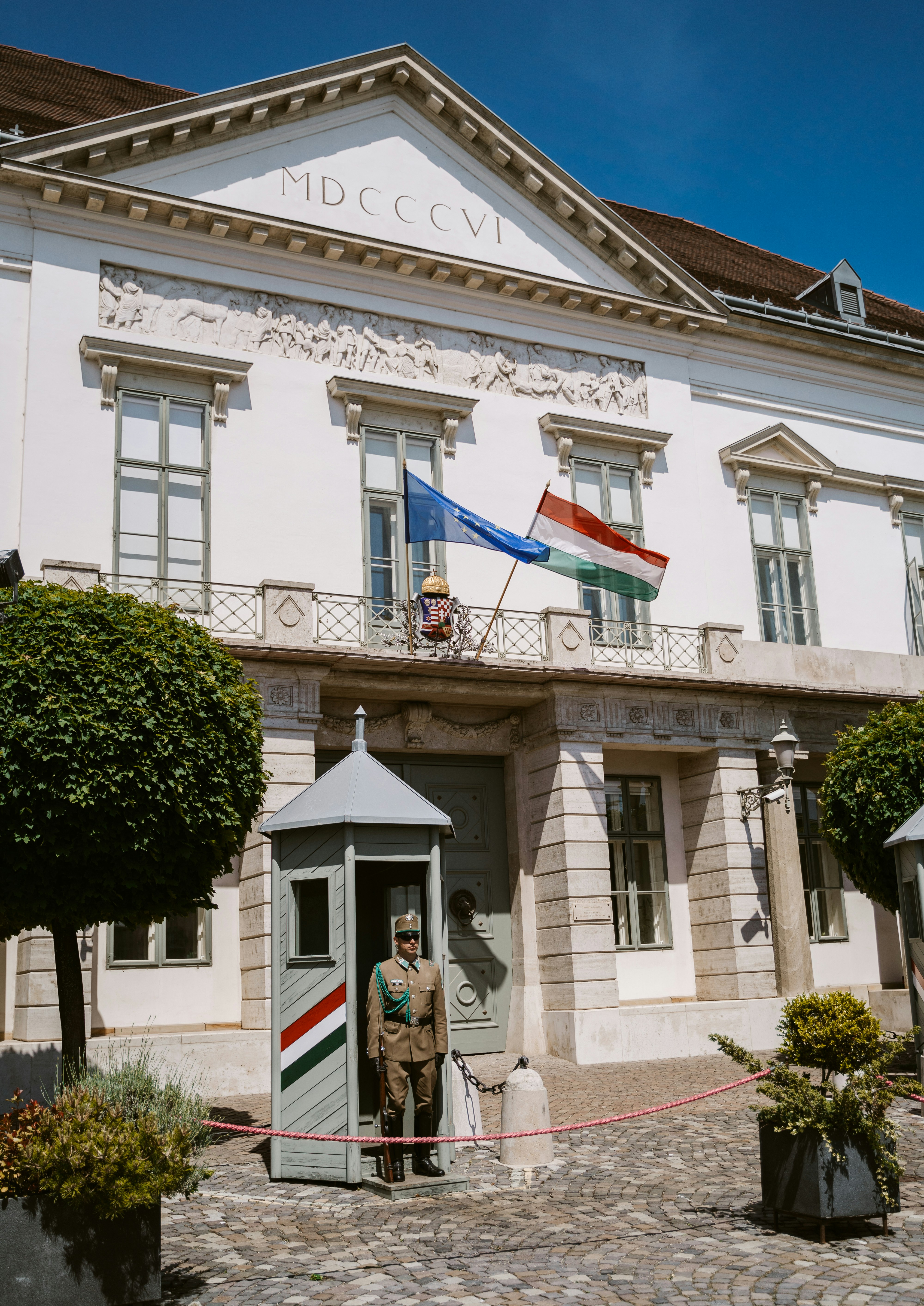 A large white building with a flag on top of it