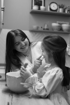 A woman and a little girl sitting on the floor