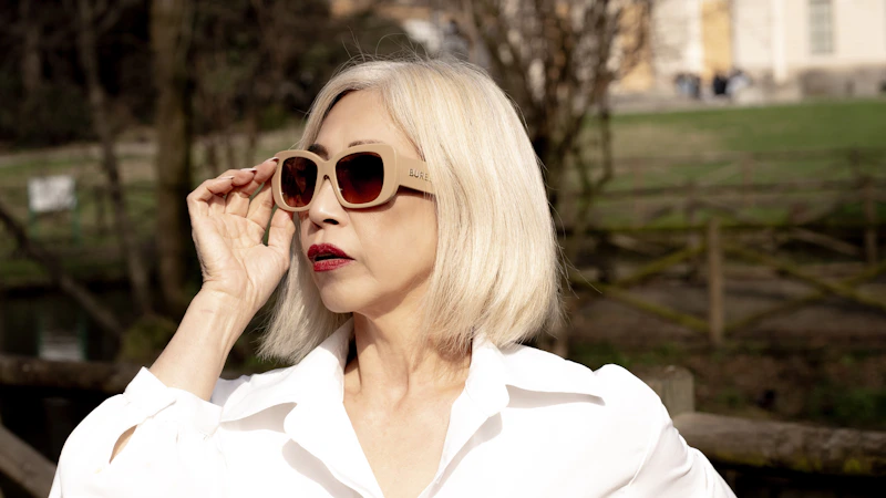 mujer madura en camisa blanca y gafas de sol