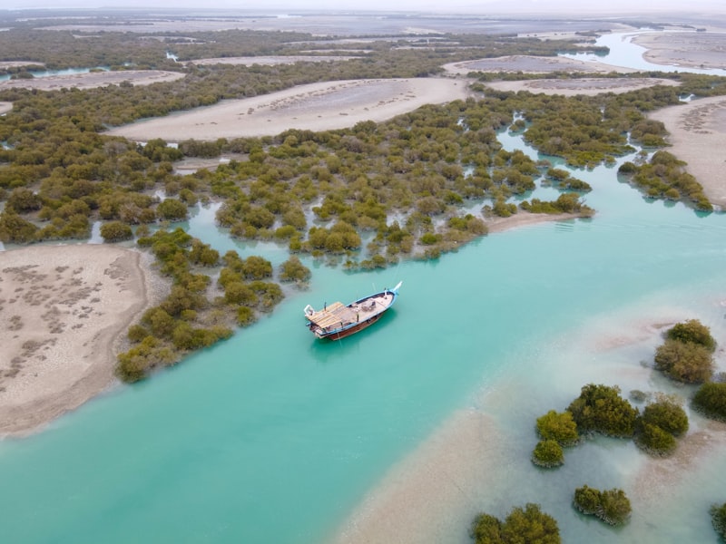 A large boat floating on top of a blue river