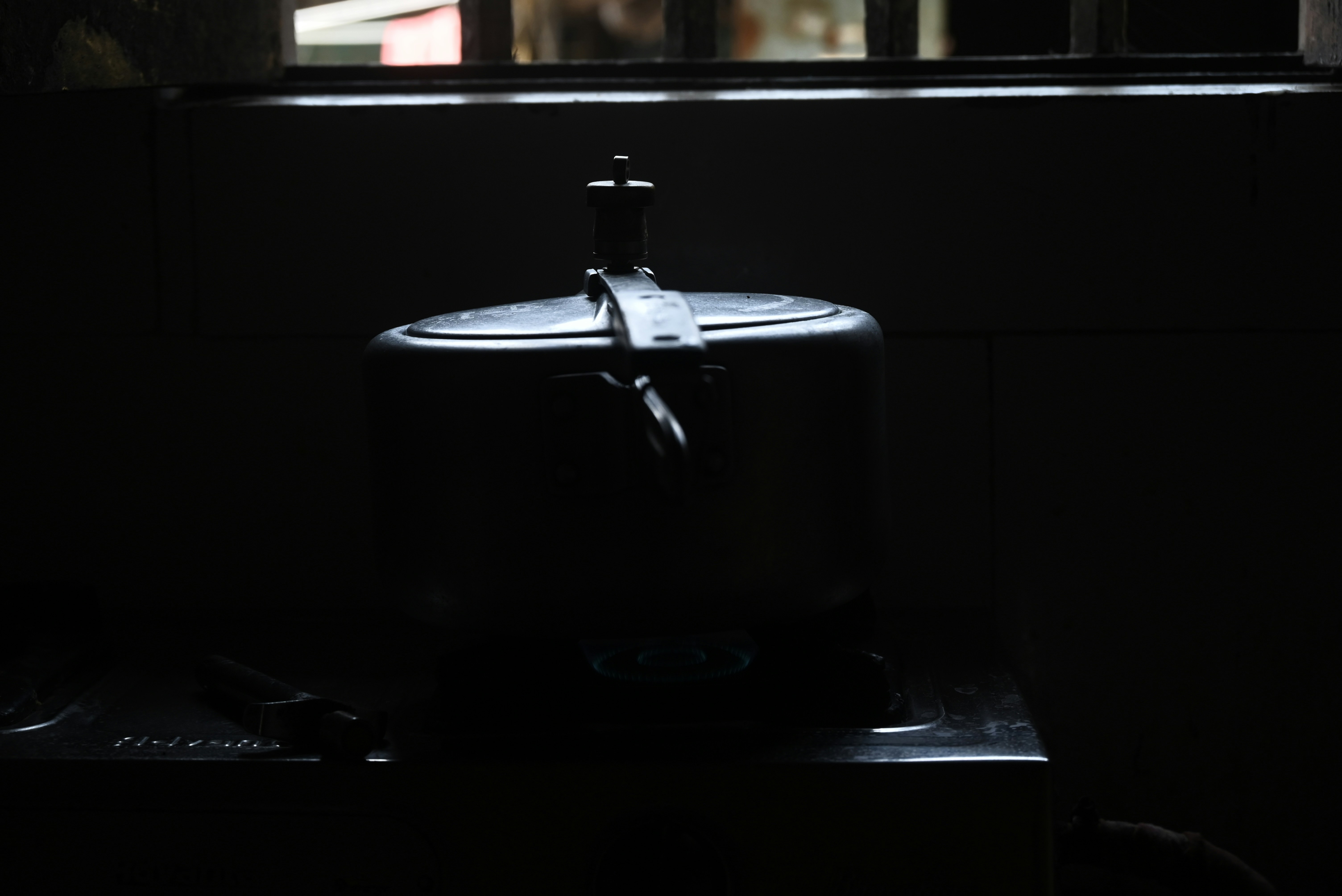 A dark room with a light coming through the window