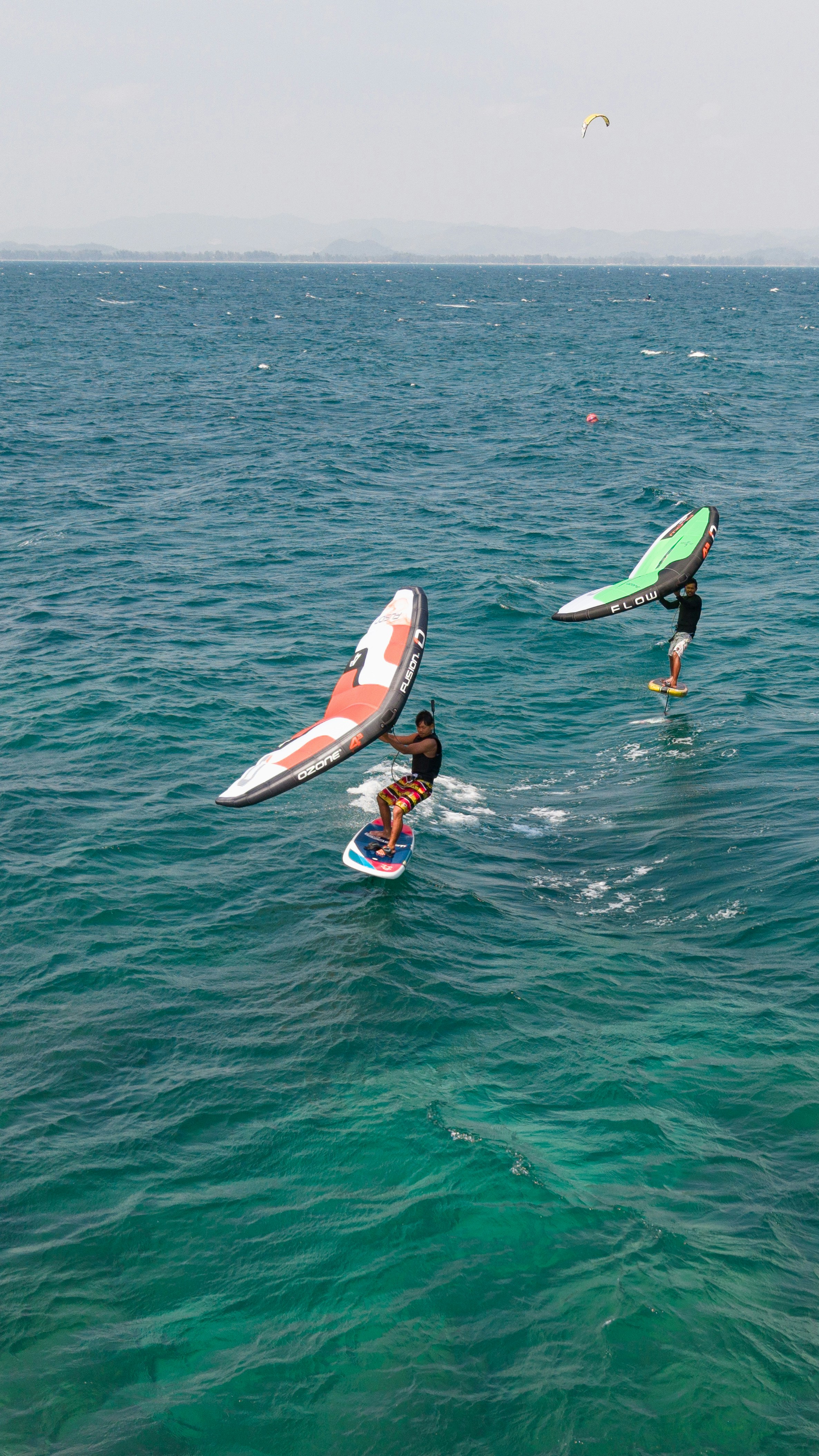 A group of people riding surfboards on top of a body of water