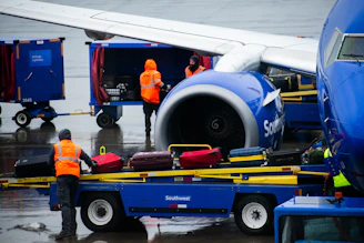 An airplane being loaded with luggage on the tarmac