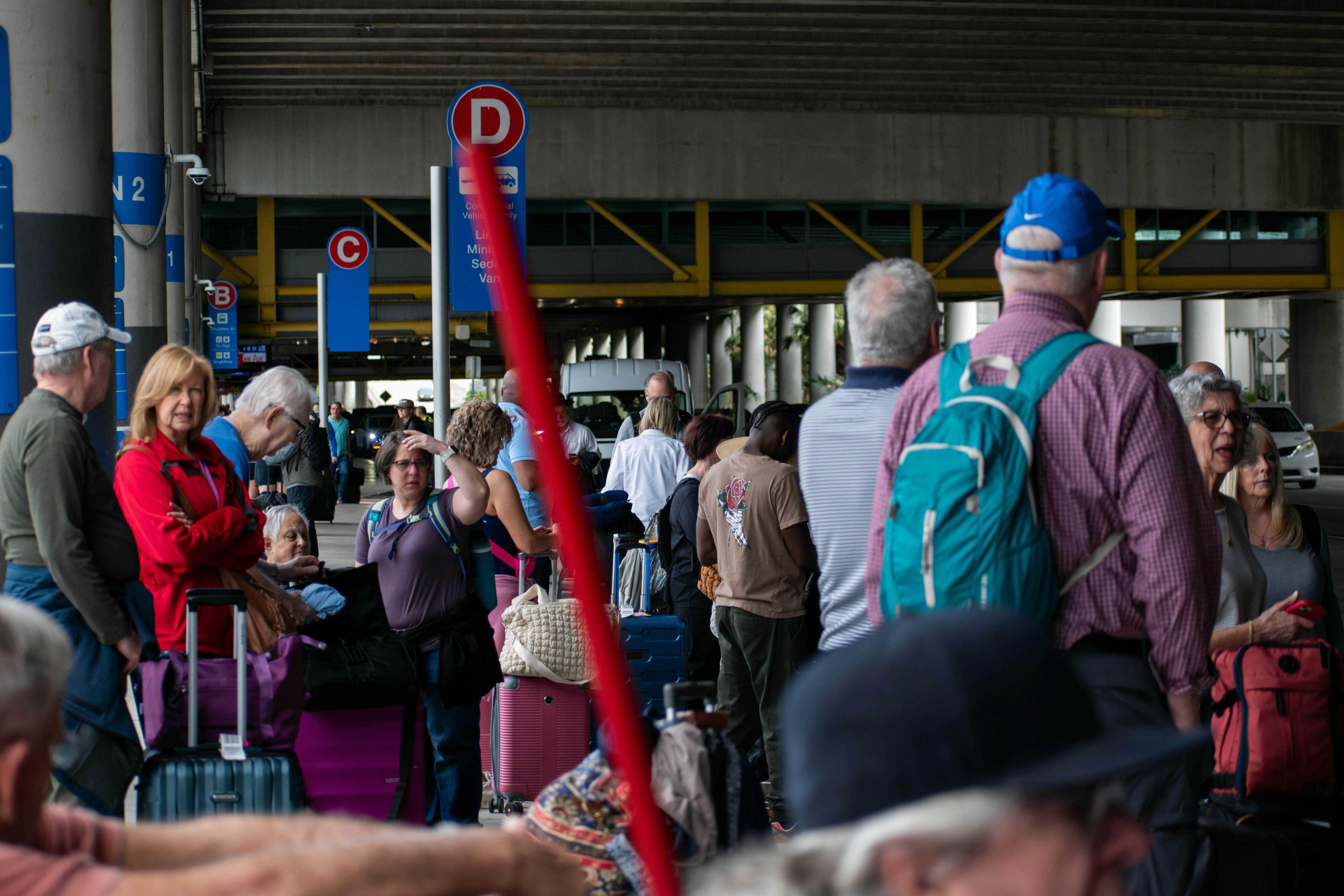 A group of people standing around with luggage