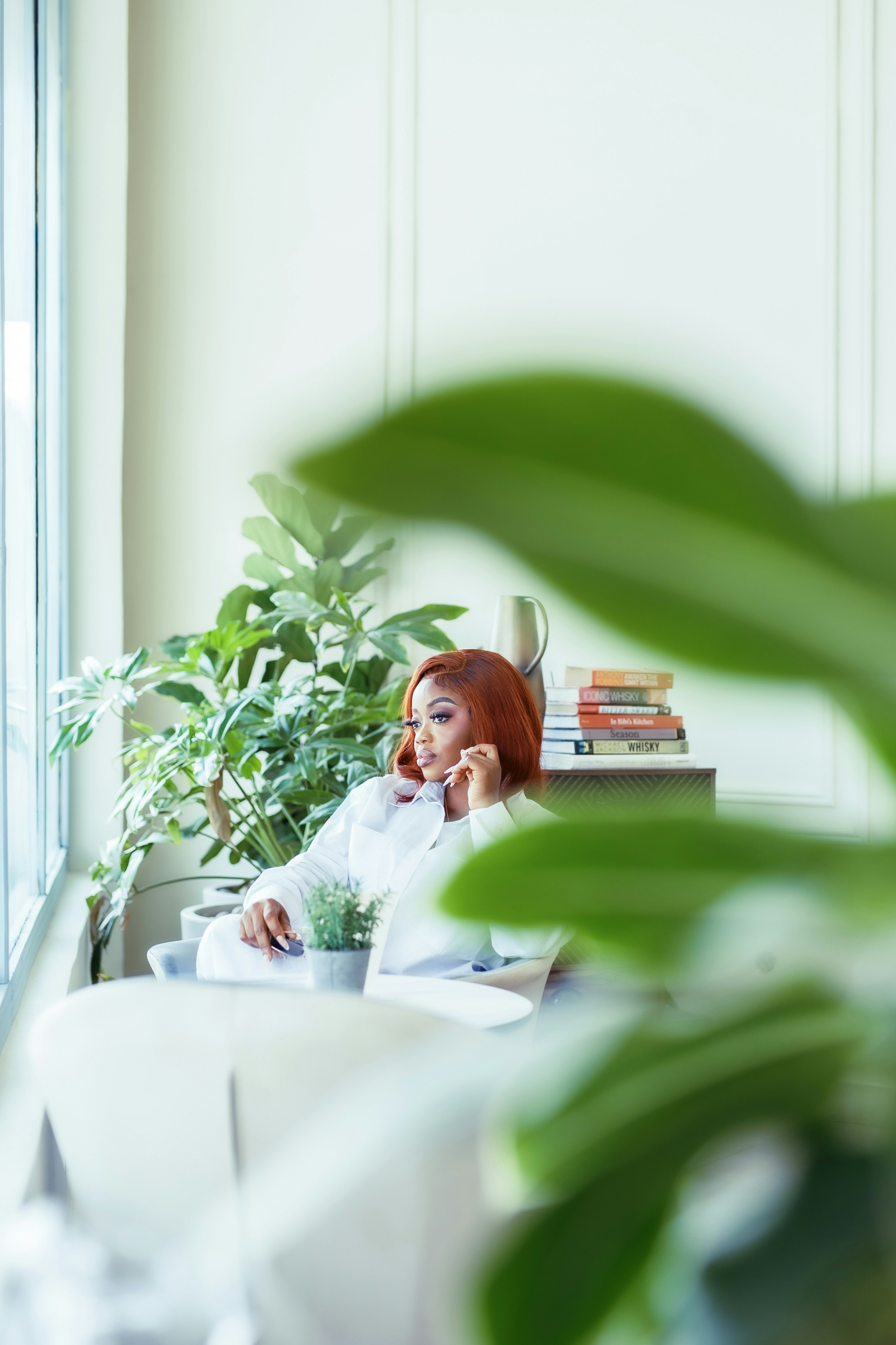 A woman sitting at a desk in front of a window
