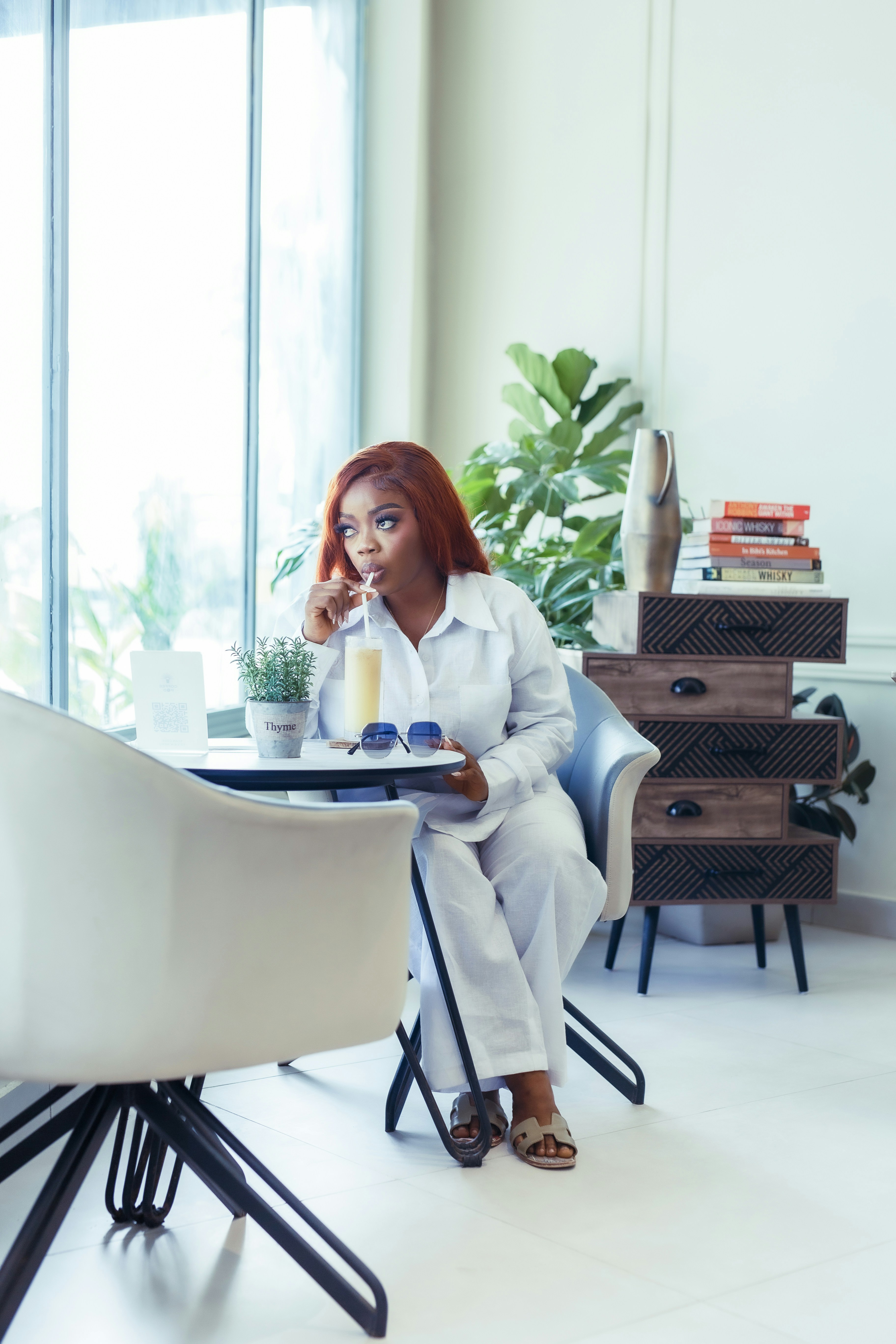 A woman sitting at a table with a plate of food