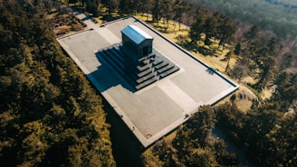 An aerial view of a building in the middle of a forest