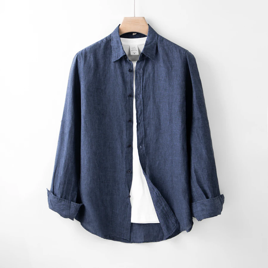 The Workshop Overshirt — navy heavyweight cotton shirt on a wooden hanger.