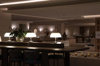 A dimly lit room with a bar and chairs