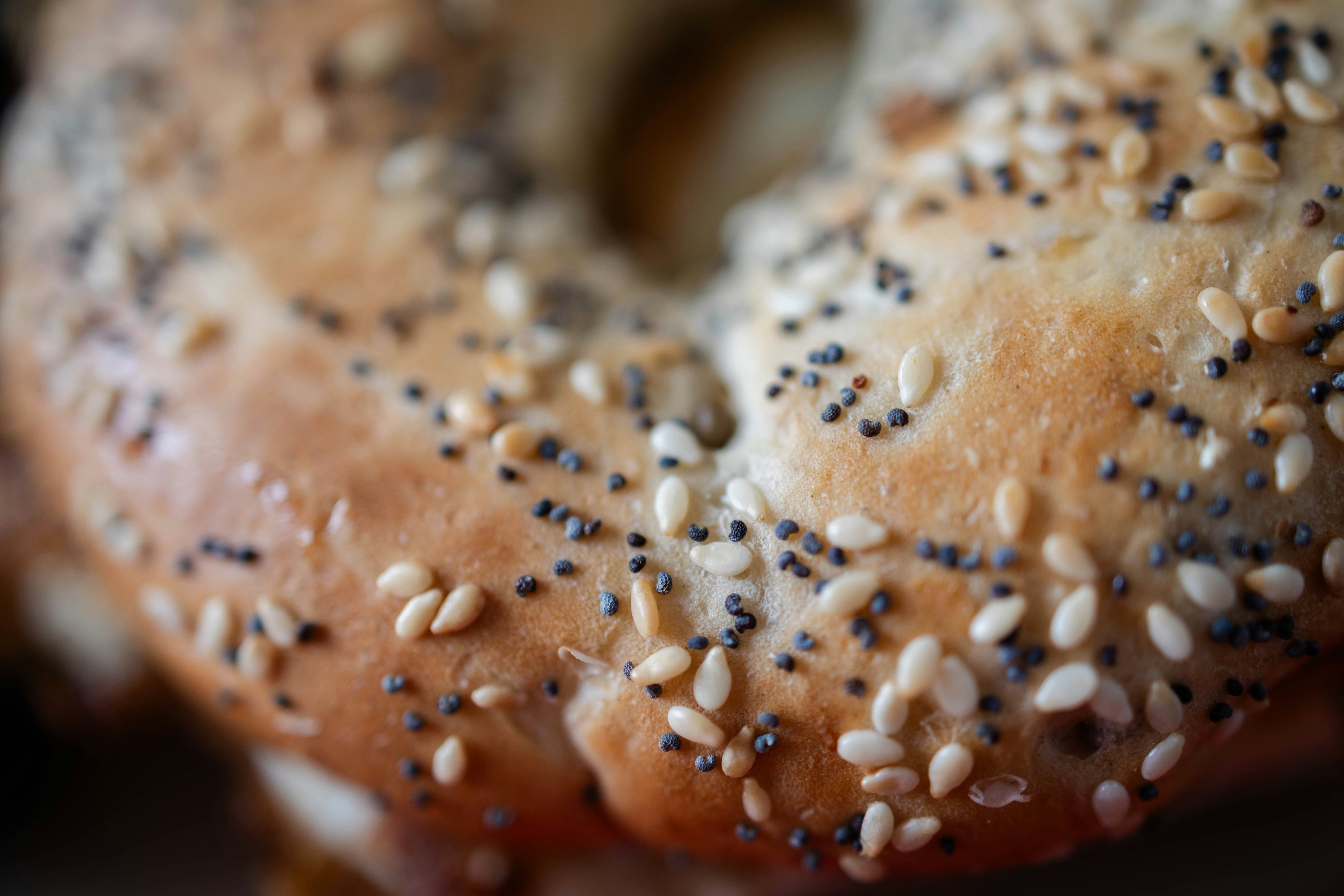 A bagel covered in sesame seeds on a plate